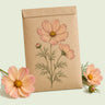 Kraft seed packet illustrated with Apricotta Cosmos, with fresh Apricotta Cosmos beside it