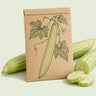 Kraft seed packet illustrated with Armenian Cucumber, with fresh Armenian Cucumber beside it