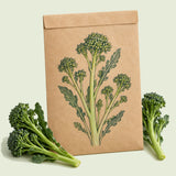Kraft seed packet illustrated with Aspabroc Sprouting Broccoli, with fresh Aspabroc Sprouting Broccoli beside it