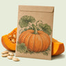 Kraft seed packet illustrated with Atlantic Giant Pumpkin, with fresh Atlantic Giant Pumpkin beside it