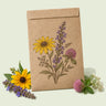 Kraft seed packet illustrated with Bee Friendly Flower Mix, with fresh Bee Friendly Flower Mix beside it