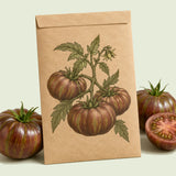 Kraft seed packet illustrated with Beefy Purple Bush Tomato, with fresh Beefy Purple Bush Tomato beside it