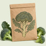 Kraft seed packet illustrated with Belstar Broccoli, with fresh Belstar Broccoli beside it