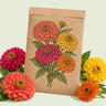 Kraft seed packet illustrated with Benary's Giant Zinnia Blend, with fresh Benary's Giant Zinnia Blend beside it
