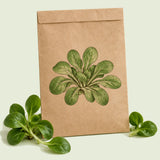 Kraft seed packet illustrated with Big Seeded M?che, with fresh Big Seeded M?che beside it