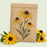 Kraft seed packet illustrated with Black-Eyed Susan, with fresh Black-Eyed Susan beside it