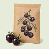 Kraft seed packet illustrated with Black Pearl Cherry Tomato, with fresh Black Pearl Cherry Tomato beside it