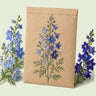 Kraft seed packet illustrated with Blue Larkspur Blend, with fresh Blue Larkspur Blend beside it