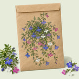 Kraft seed packet illustrated with Cascade of Color Trailing Lobelia, with fresh Cascade of Color Trailing Lobelia beside it