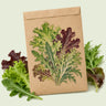 Kraft seed packet illustrated with Chef's Choice Mesclun Greens, with fresh Chef's Choice Mesclun Greens beside it