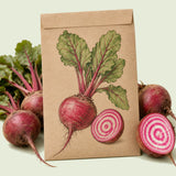 Kraft seed packet illustrated with Chioggia Beet, with fresh Chioggia Beet beside it