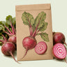 Kraft seed packet illustrated with Chioggia Beet, with fresh Chioggia Beet beside it