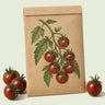 Kraft seed packet illustrated with Chocolate Cherry Pole Cherry Tomato, with fresh Chocolate Cherry Pole Cherry Tomato beside it