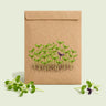 Kraft seed packet illustrated with Ciao Bella Basil Blend Microgreens, with fresh Ciao Bella Basil Blend Microgreens beside it