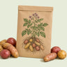 Kraft seed packet illustrated with Clancy Potato, with fresh Clancy Potato beside it