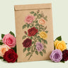 Kraft seed packet illustrated with Climbing Rose, with fresh Climbing Rose beside it
