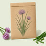 Kraft seed packet illustrated with Common Chives Herb, with fresh Common Chives Herb beside it