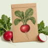 Kraft seed packet illustrated with Crimson Giant Radish, with fresh Crimson Giant Radish beside it