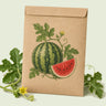 Kraft seed packet illustrated with Crimson Sweet Watermelon, with fresh Crimson Sweet Watermelon beside it