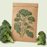 Kraft seed packet illustrated with Di Cicco Broccoli, with fresh Di Cicco Broccoli beside it