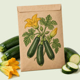Kraft seed packet illustrated with Emerald Delight Summer Squash, with fresh Emerald Delight Summer Squash beside it