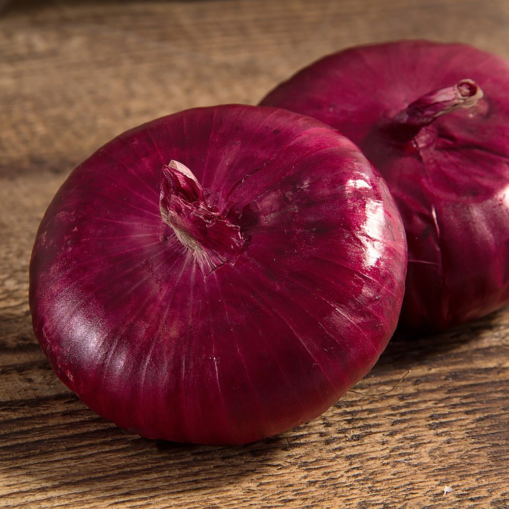 Flat of Italy Bulb Cipollini Onion growing in a garden
