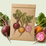 Kraft seed packet illustrated with Gourmet Beet Blend, with fresh Gourmet Beet Blend beside it