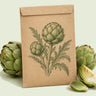 Kraft seed packet illustrated with Green Globe Improved Artichoke, with fresh Green Globe Improved Artichoke beside it