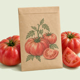 Kraft seed packet illustrated with Halladay Mortgage Lifter Tomato, with fresh Halladay Mortgage Lifter Tomato beside it