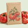 Kraft seed packet illustrated with Halladay Mortgage Lifter Tomato, with fresh Halladay Mortgage Lifter Tomato beside it