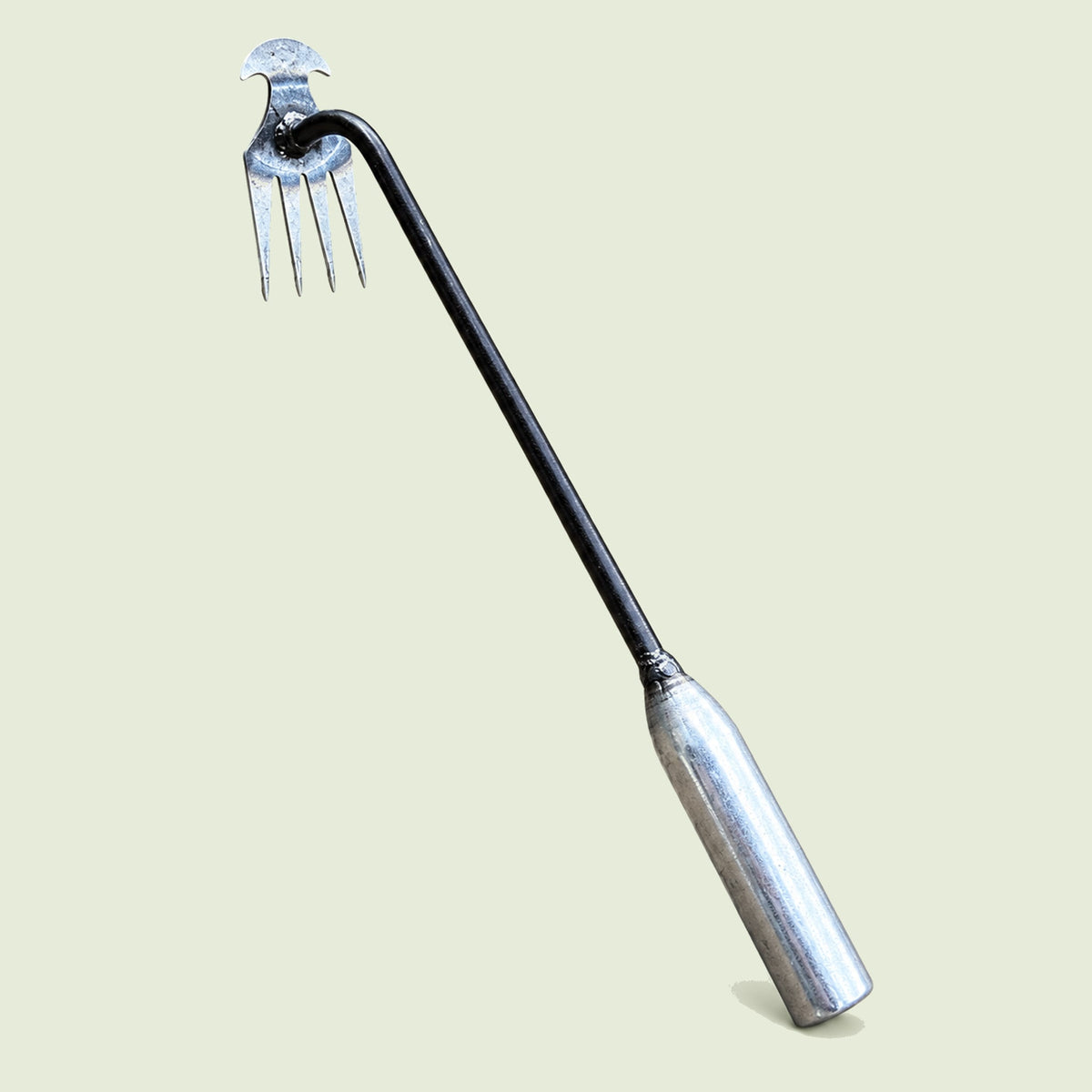 Hand Weed Puller on a soft green background