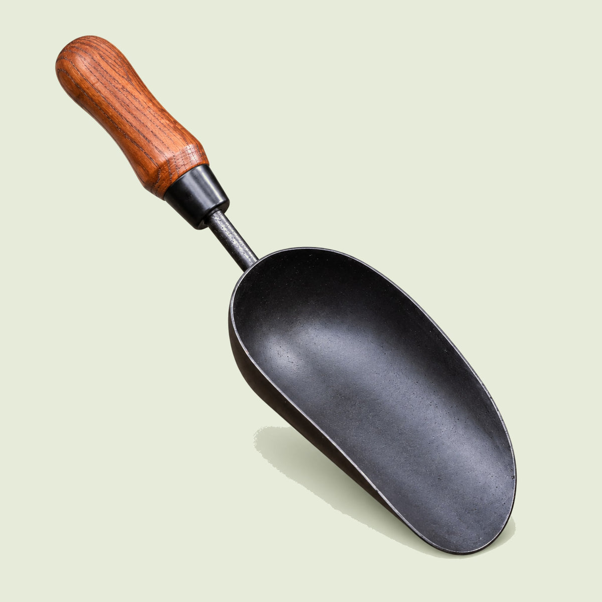 Handheld Garden Soil Scoop on a soft green background