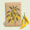 Kraft seed packet illustrated with Lemon Drop Chile Pepper, with fresh Lemon Drop Chile Pepper beside it