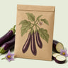 Kraft seed packet illustrated with Long Purple Eggplant, with fresh Long Purple Eggplant beside it