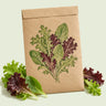 Kraft seed packet illustrated with Mesclun Six Lettuce Blend, with fresh Mesclun Six Lettuce Blend beside it