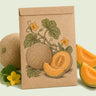 Kraft seed packet illustrated with Minnesota Midget Cantaloupe, with fresh Minnesota Midget Cantaloupe beside it