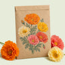 Kraft seed packet illustrated with Mission Bells California Poppy, with fresh Mission Bells California Poppy beside it