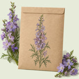 Kraft seed packet illustrated with Misty Lavender Larkspur, with fresh Misty Lavender Larkspur beside it
