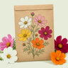 Kraft seed packet illustrated with Mixed Cosmos, with fresh Mixed Cosmos beside it