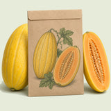 Kraft seed packet illustrated with Navajo Yellow Melon, with fresh Navajo Yellow Melon beside it