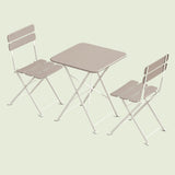 Outdoor Bistro Table and Chairs on a soft green background