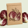 Kraft seed packet illustrated with Palla Rossa Mavrik Radicchio, with fresh Palla Rossa Mavrik Radicchio beside it