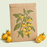 Kraft seed packet illustrated with Patio Choice Yellow Cherry Tomato, with fresh Patio Choice Yellow Cherry Tomato beside it