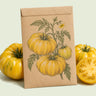 Kraft seed packet illustrated with Pork Chop Yellow Tomato, with fresh Pork Chop Yellow Tomato beside it