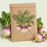 Kraft seed packet illustrated with Purple Top White Globe Turnip, with fresh Purple Top White Globe Turnip beside it