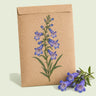 Kraft seed packet illustrated with Rocky Mountain Blue Penstemon, with fresh Rocky Mountain Blue Penstemon beside it