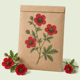 Kraft seed packet illustrated with Scarlet Cinquefoil, with fresh Scarlet Cinquefoil beside it