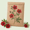 Kraft seed packet illustrated with Scarlet Cinquefoil, with fresh Scarlet Cinquefoil beside it