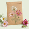Kraft seed packet illustrated with Sea Shells Blend Cosmos, with fresh Sea Shells Blend Cosmos beside it