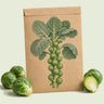 Kraft seed packet illustrated with Silvia Brussels Sprouts, with fresh Silvia Brussels Sprouts beside it
